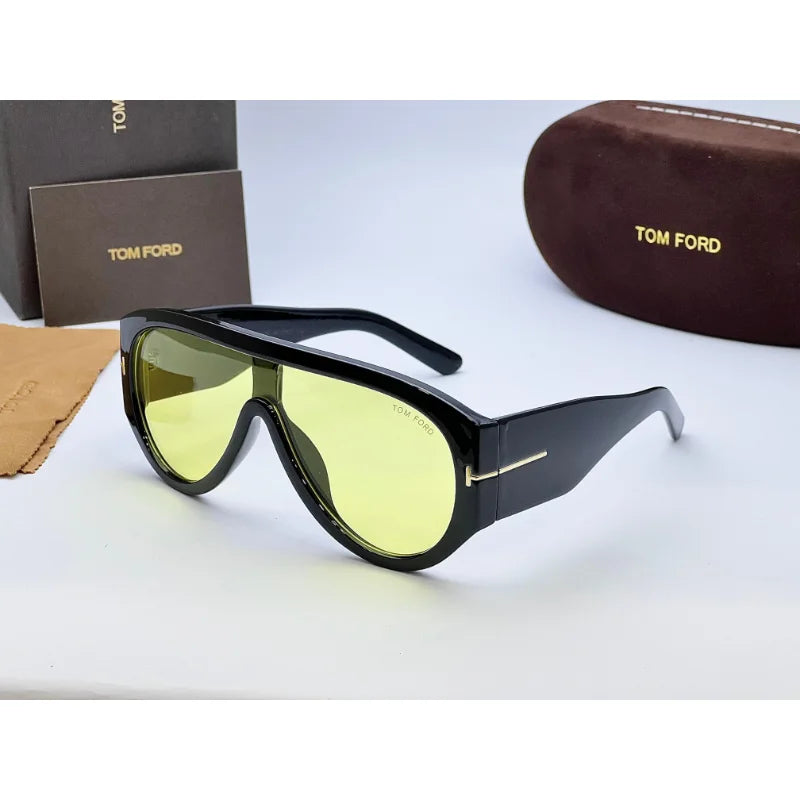 Close-up of Tom Ford Bronson sunglasses side view showing signature gold T logo on temples
