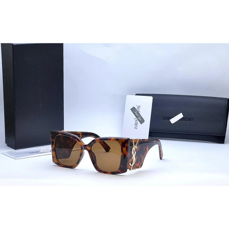 Close-up of Saint Laurent Blaze brown sunglasses side angle with YSL Paris logo on temple with box